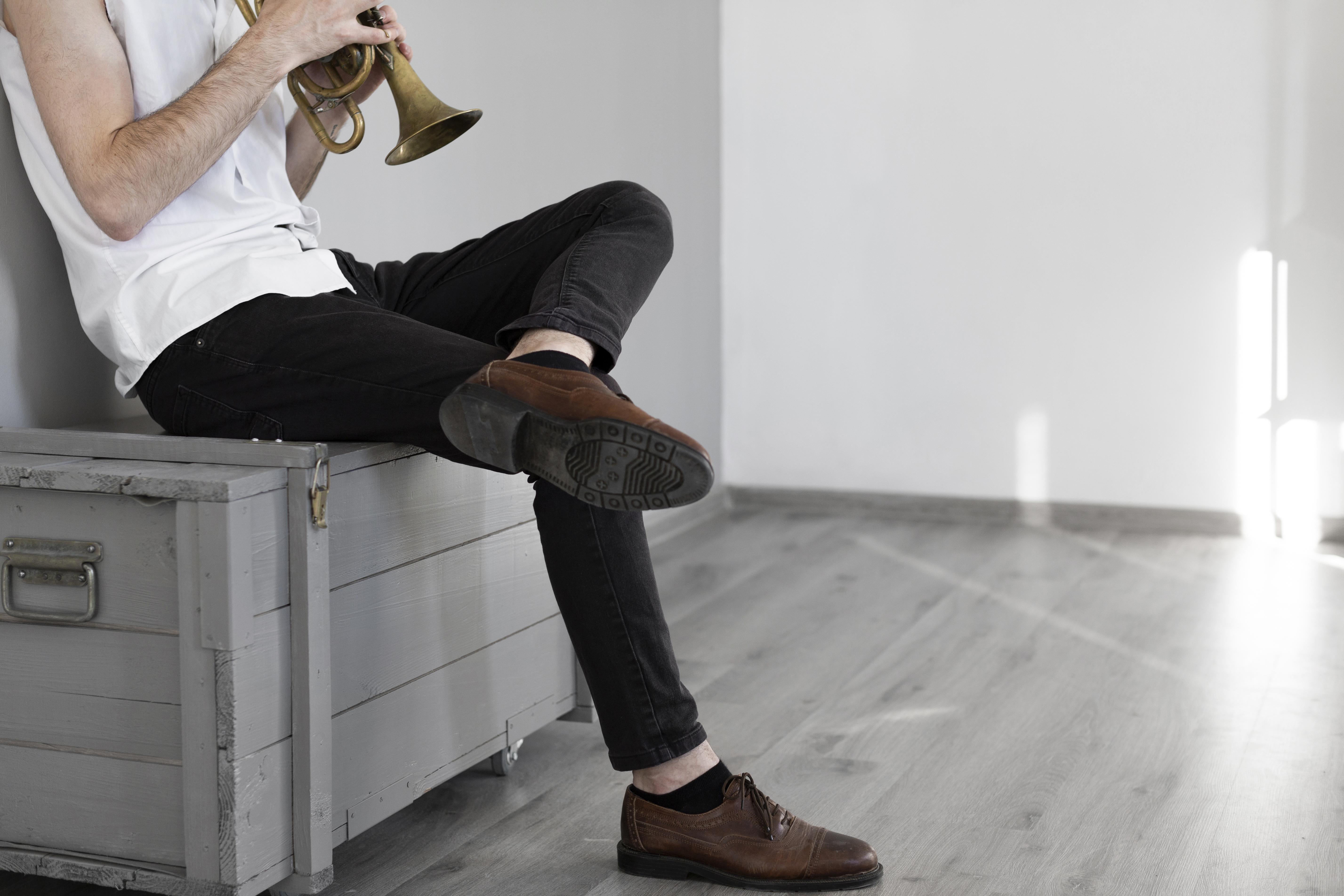 mężczyzna gra na instumencie w mieszkaniu